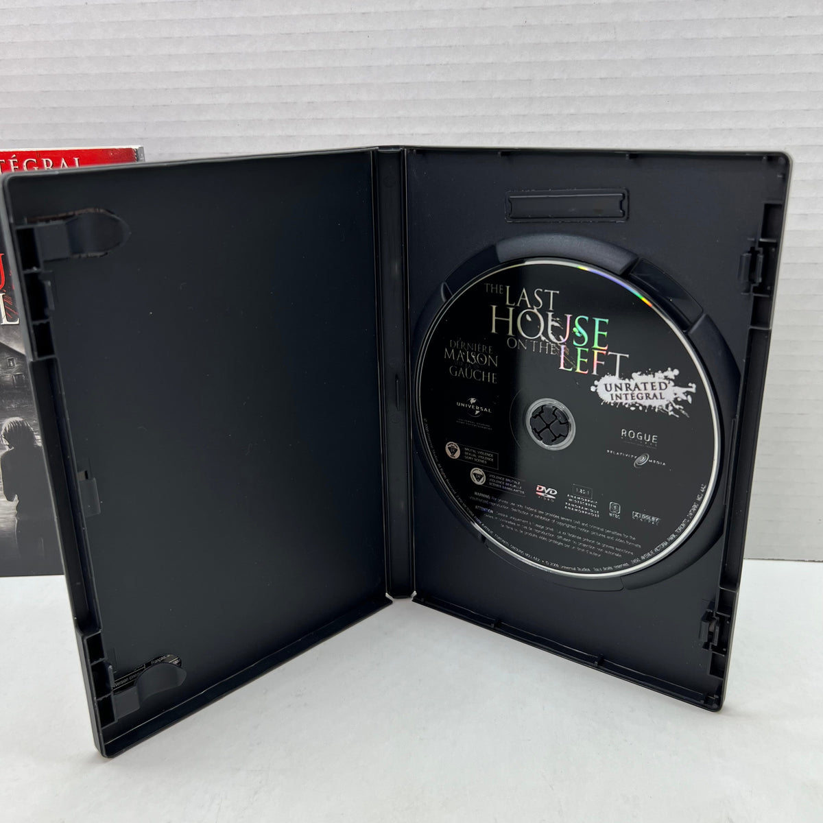 Open case showing disc of The Last House on the Left [DVD]