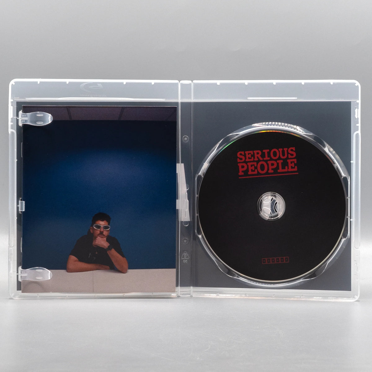 Open case showing disc art of Serious People [Blu-ray]